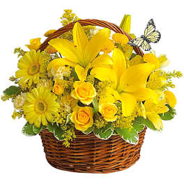 Yellow flowers arranged in a wicker basket with a butterfly decoration