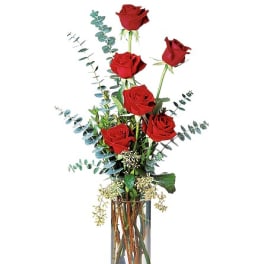 Tall vase arrangement of red roses with eucalyptus