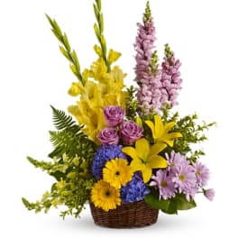 Colorful mixed flower arrangement in a wicker basket