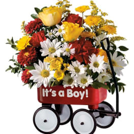 Flower arrangement in a red wagon with "It's a Boy!" text