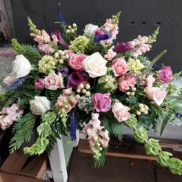Large pink and white floral arrangement with roses and calla lilies
