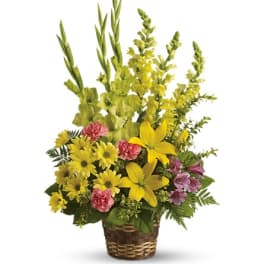 Yellow and pink mixed flowers in a wicker basket