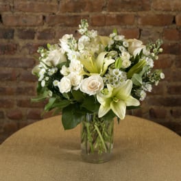 White floral arrangement in a clear glass vase