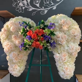 Large heart-shaped floral arrangement with cream and peach roses