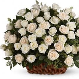 White roses arranged in a wicker basket