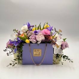 Lavender box arrangement with pastel roses, tulips, and orchids