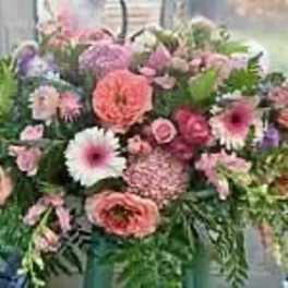 Mixed pink and purple flower arrangement in a vase