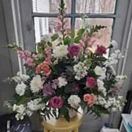 Mixed pink and white floral arrangement in a gold vase