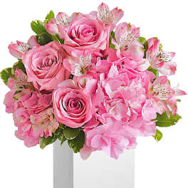 Pink roses and hydrangeas in a white square vase