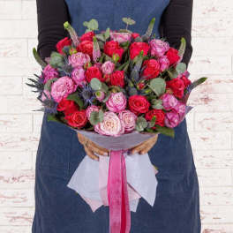 Handheld bouquet of pink and red roses with eucalyptus and ribbon wrap
