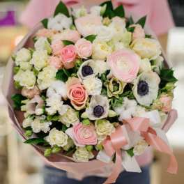 Bouquet of pale pink and white flowers wrapped in pink paper