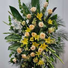 Tall floral spray with cream roses and yellow lilies