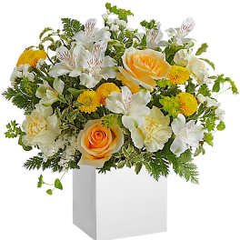 Bouquet of white alstroemeria and yellow roses in a white vase