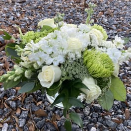 White and green floral arrangement in a glass vase