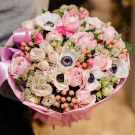 Pink and white bouquet with anemones and roses wrapped in pink paper