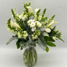 White floral bouquet in a clear glass vase