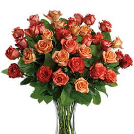 Bouquet of orange and red roses in a clear glass vase