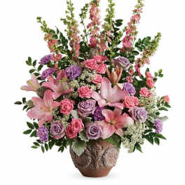 Pink and lavender floral arrangement in a decorative vase