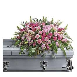 Pink floral casket spray with roses and lilies