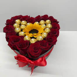 Heart-shaped box of red roses with a sunflower and gold chocolates