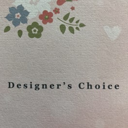 Designer’s Choice text with a small floral logo above it