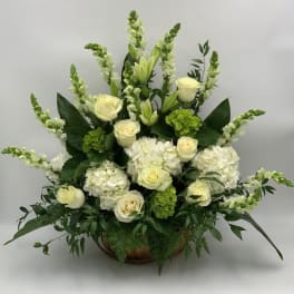 White roses and hydrangeas arranged in a low bowl