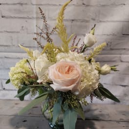 Blush rose and white hydrangea arrangement in a glass vase