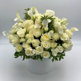 White roses and calla lilies in a white hatbox