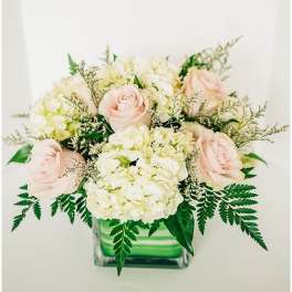 Bouquet of pale pink roses and white hydrangeas in a glass vase