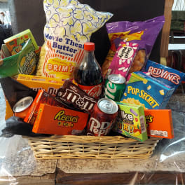Basket of assorted snacks and soda wrapped in clear cellophane