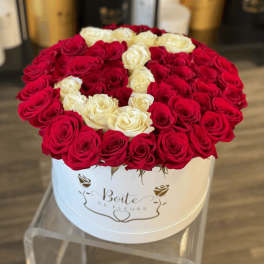 Round box of red and white roses arranged in a heart pattern