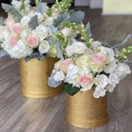 Two pastel rose arrangements in gold boxes