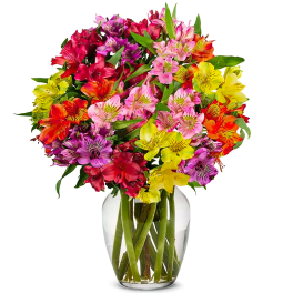 Colorful bouquet of alstroemeria in a clear glass vase
