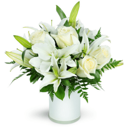 White lilies and roses arranged in a white vase