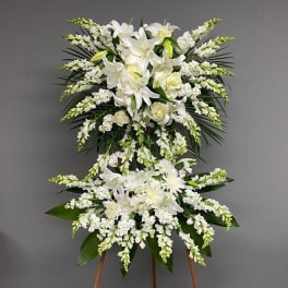 White floral standing spray on an easel