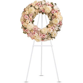 Pastel floral wreath on a white easel stand