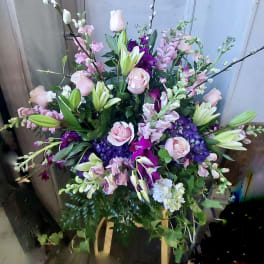 Large bouquet of pink roses, lilies, and purple flowers