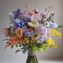 Colorful bouquet of mixed flowers in pink, blue, purple, and yellow