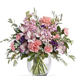 Pink and purple mixed bouquet in a clear glass vase