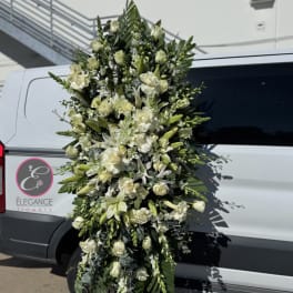 Tall white floral standing spray with lilies and roses