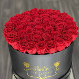 Round box filled with red roses