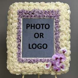 Rose-covered square easel display with a photo or logo center and orchids at the lower right