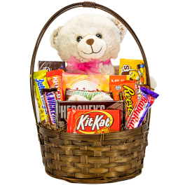 Teddy bear in a basket with assorted candy bars