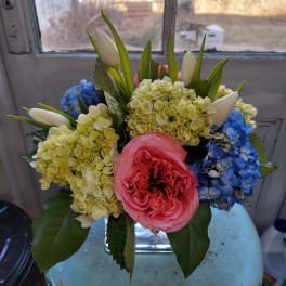 Bouquet of pink roses, blue hydrangeas, and white tulips