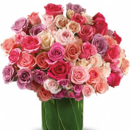 Bouquet of pink and lavender roses in a glass vase