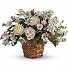 White and pale pink flowers in a woven basket