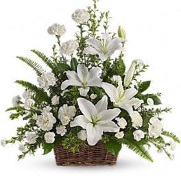 White lilies and carnations in a wicker basket