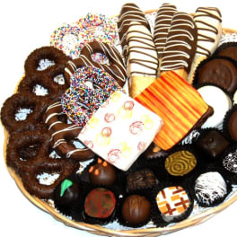 Basket of assorted chocolate-covered treats and decorated cookies