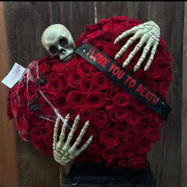 Heart-shaped red rose arrangement with skeleton hands, skull, and a "I LOVE YOU TO DEATH" ribbon