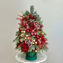 Red roses and pinecones arranged in a green container